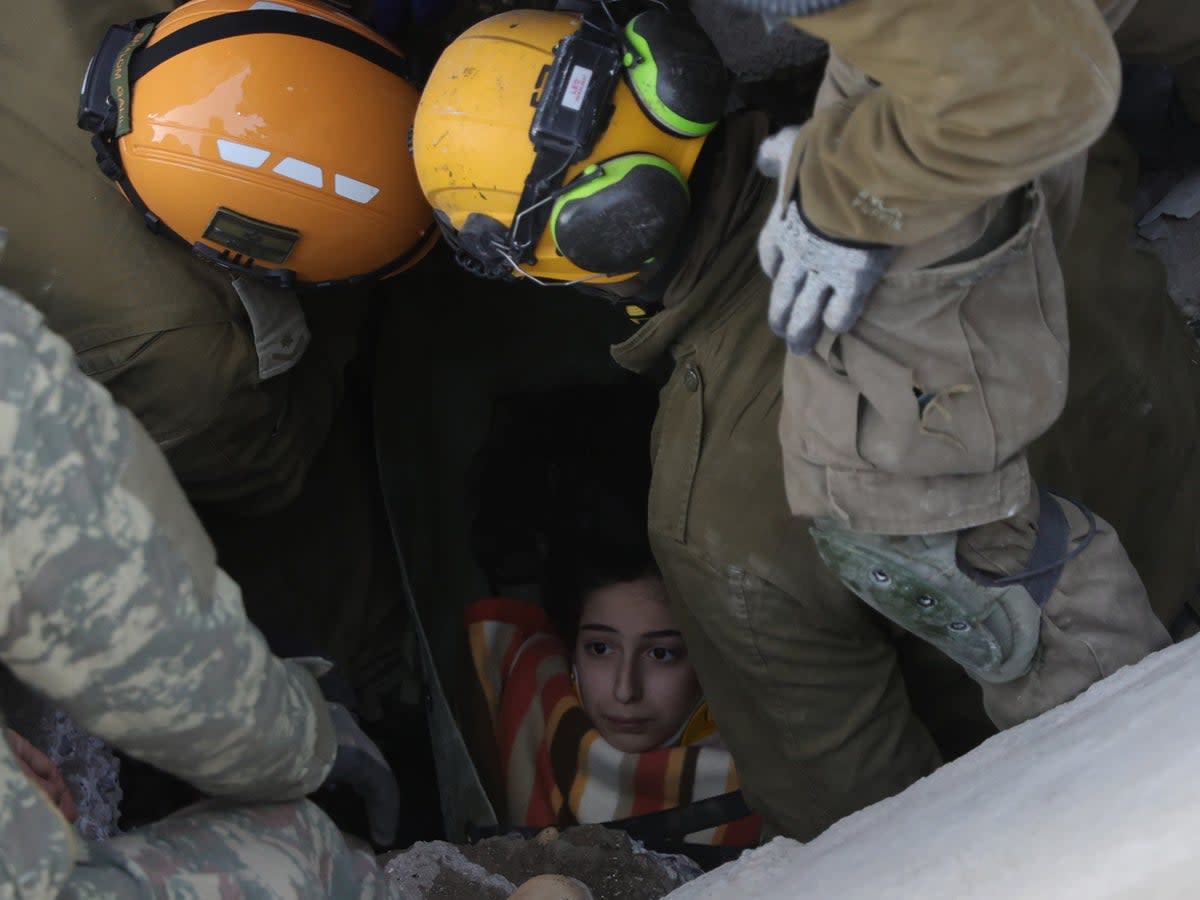 A teenage girl is pulled alive from rubble in Turkey (EPA)