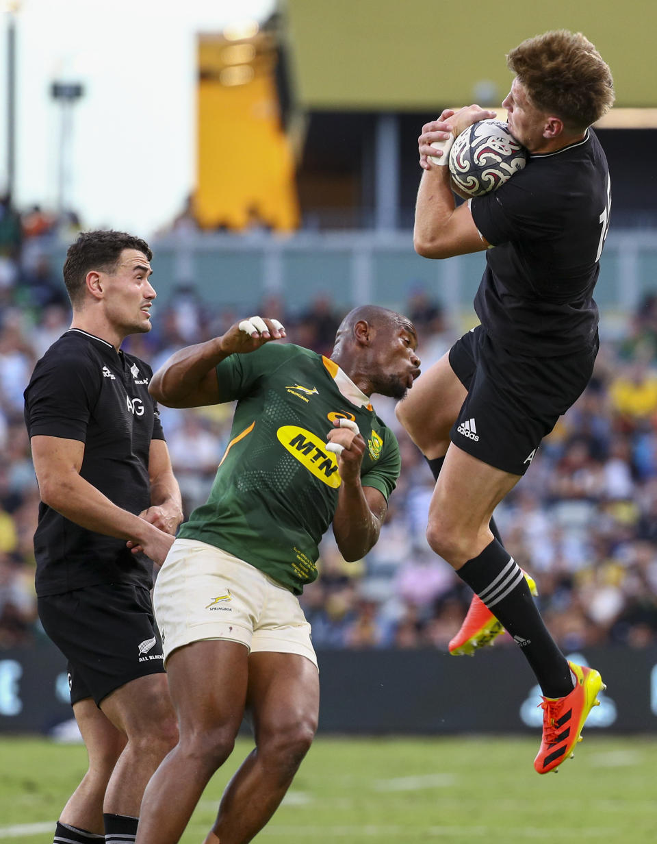 New Zealand's Jordie Barrett leaps to catch the ball during the Rugby Championship test match between the Springboks and the All Blacks in Townsville, Australia, Saturday, Sept. 25, 2021. (AP Photo/Tertius Pickard)