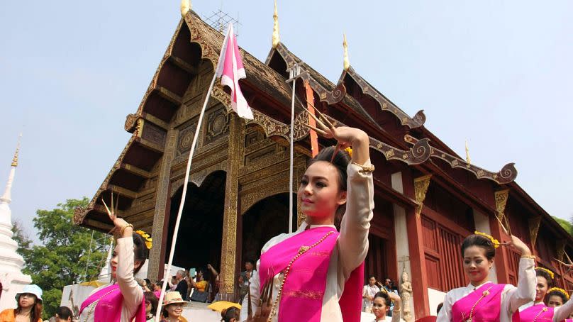 Thai dancers perform a group classical dance during Songkran festival at Phra Singha temple in Chiang Mai province, 2014.