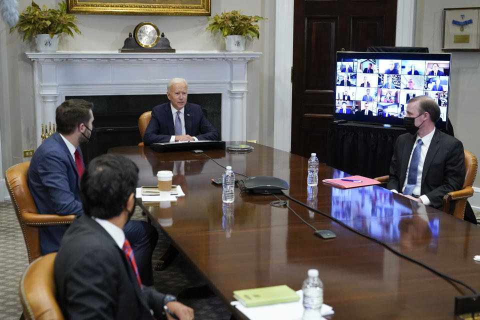 President Joe Biden participates virtually in the CEO Summit on Semiconductor and Supply Chain Resilience in the Roosevelt Room of the White House, Monday, April 12, 2021, in Washington. Seated with Biden are Daleep Singh, Deputy National Security Adviser and Deputy Director of the National Economic Council, clockwise from bottom left, National Economic Council Director Brian Deese and National Security Adviser Jake Sullivan. (AP Photo/Patrick Semansky)