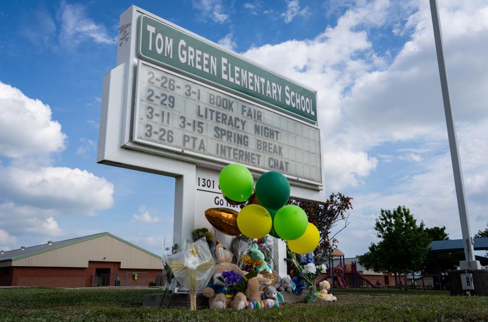 A memorial stands at Tom Green Elementary School in Buda on Saturday, a day after a class was involved in a bus crash that left one student dead.