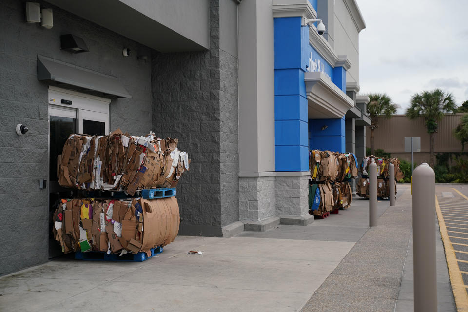 <p>The glass doors of a store in Tampa are covered with cardboard boxes on Sept. 27.</p>