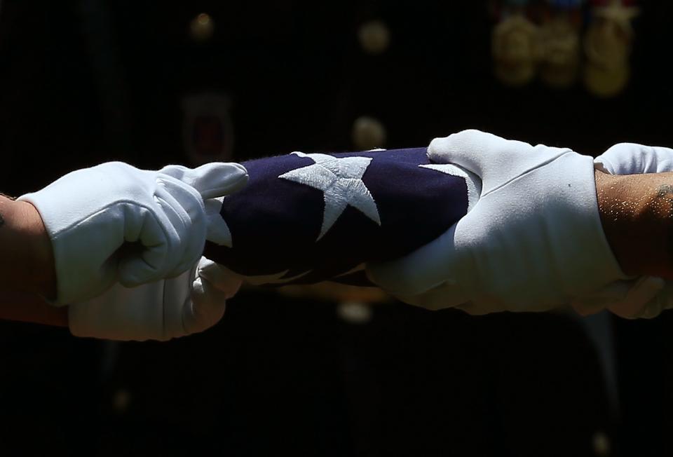 Members of the U.S. Army fold an American flag in Arlington, Va., on June 8th, 2015.