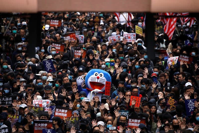 A person dressed in a costume of anime character Doraemon attends an anti-government demonstration on New Year's Day to call for better governance and democratic reforms in Hong Kong