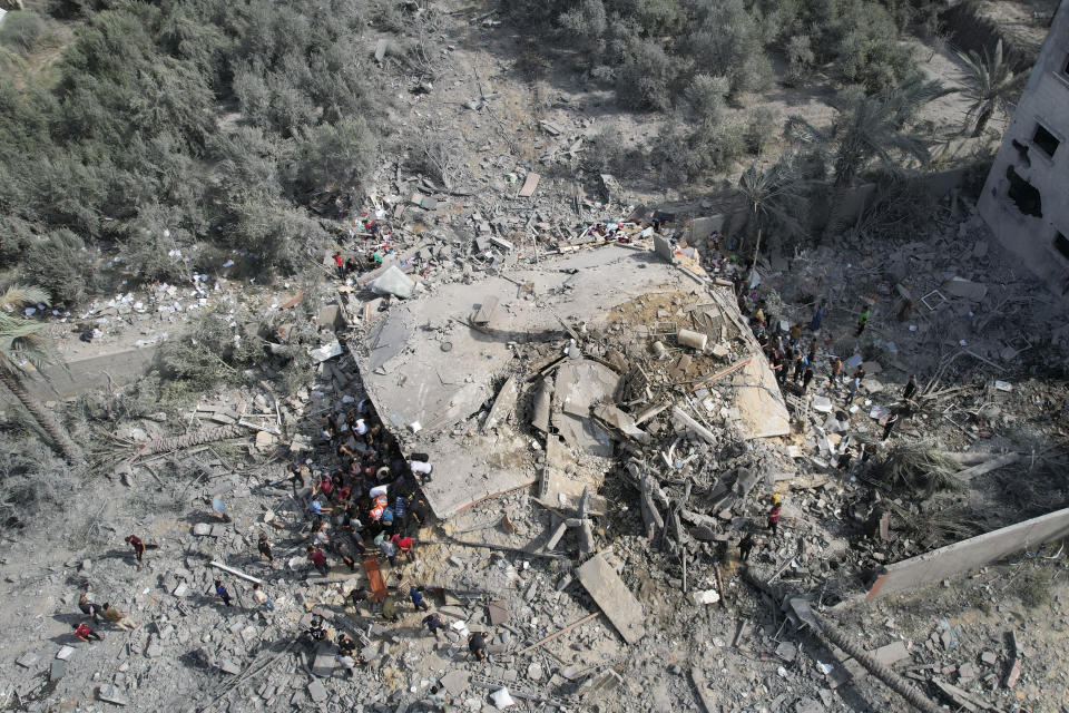 FILE - Palestinians look for survivors after the Israeli bombardment of the Gaza Strip in Deir Al-Balah on Oct. 22, 2023. U.N. humanitarian monitors say at least 2,700 people, including 1,500 children, are missing and believed buried under the rubble. (AP Photo/Hatem Moussa, File)