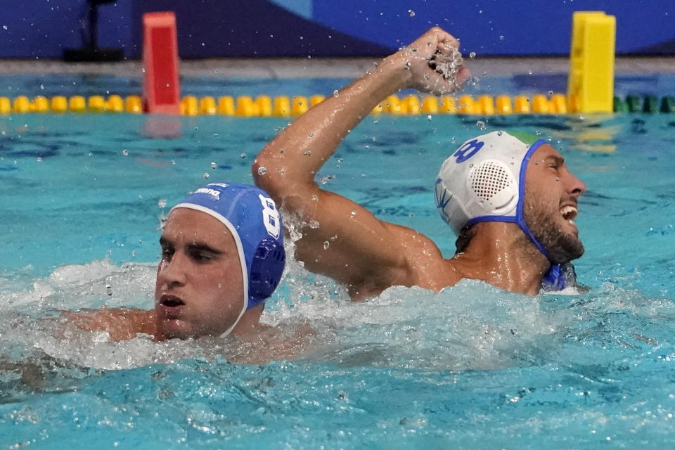 Italy's Gonzalo Echenique, right, celebrates after scoring past Greece's Stylianos Argyropoulos Kanakakis, left, during a preliminary round men's water polo match at the 2020 Summer Olympics, Tuesday, July 27, 2021, in Tokyo, Japan. (AP Photo/Mark Humphrey)