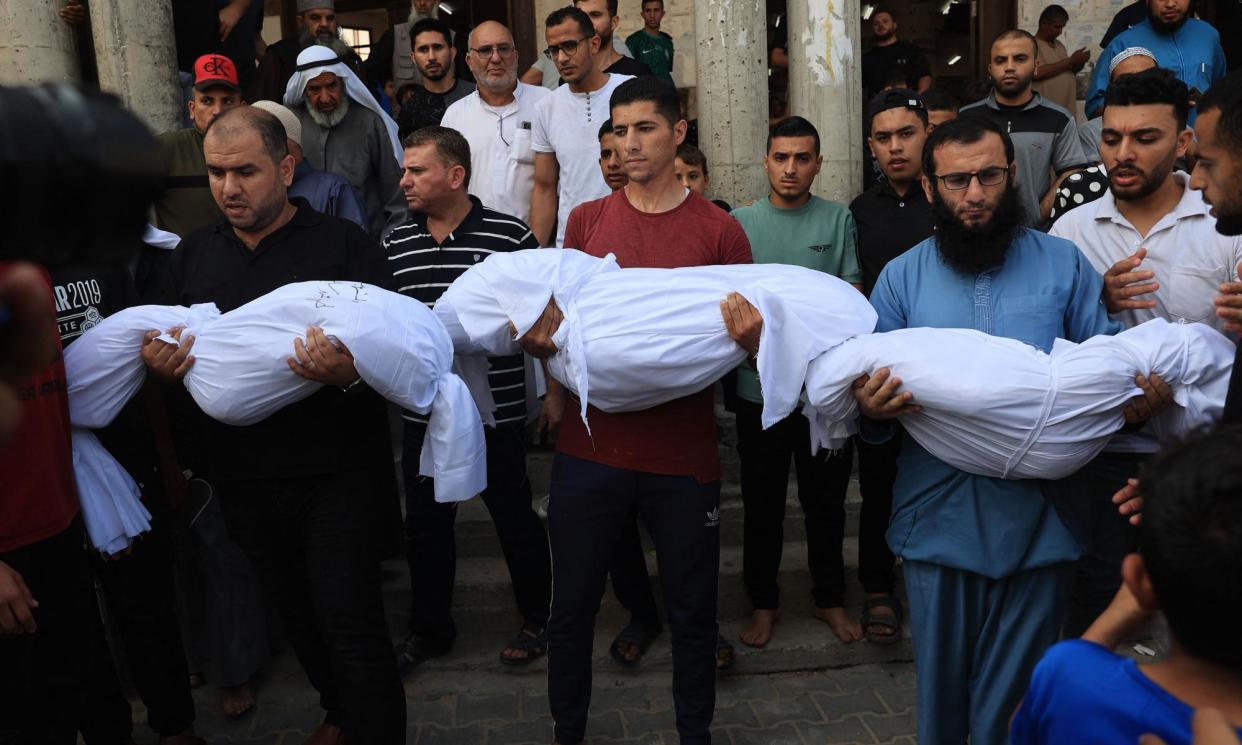 <span>Relatives carry the bodies of children from the Abu Quta family killed by Israeli strikes on Rafah, during their funeral.</span><span>Photograph: AFP/Getty Images</span>