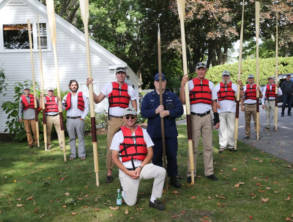 Rowers gather to get their gear and new oars at Sam Reid's home in Kittery Point, Maine, before they rowed to Wood Island Lifesaving Station in the Mervin F Roberts, the fully restored 1930s rescue boat, Friday, Sept. 30, 2022.