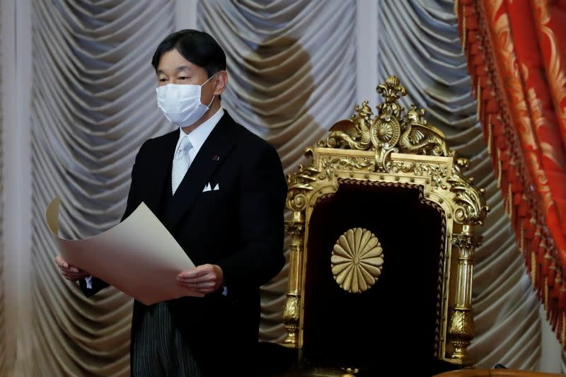 Japan's Emperor Naruhito wearing a protective face mask speaks during the opening of an extraordinary session of parliament in Tokyo