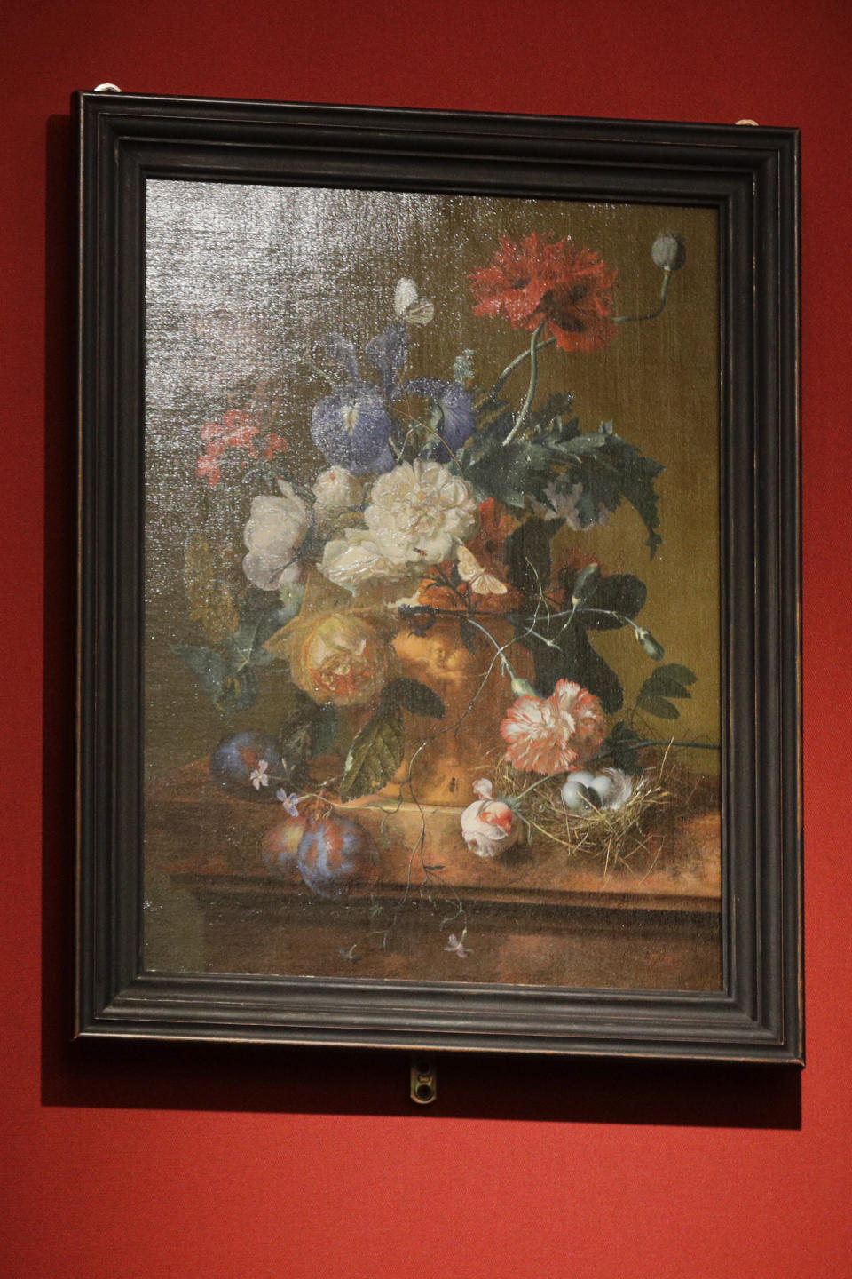 The "Vase of Flowers" painting by Jan van Huysum, is seen during a ceremony at the Pitti Palace, part of the Uffizi Galleries, in Florence, Italy, Friday, July 19, 2019. Germany returned the Dutch still-life after it was stolen by Nazi troops during WWII. (AP Photo/Gregorio Borgia)