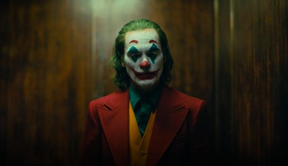 Arthur Fleck dressed as The Joker in an elevator in "Joker"