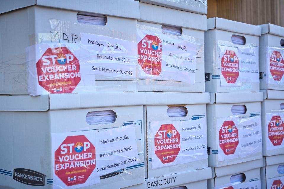 Boxes containing signatures from Maricopa County in favor of deferring the statewide voucher expansion are stacked at the Arizona Capitol in Phoenix  before being carted off to a storage room on Friday, Sept. 23, 2022.