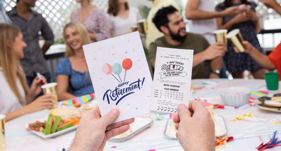 A man holds a Set For Life ticket and a Happy Retirement card. Source: The Lott