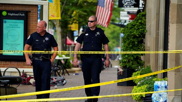 PHOTO: Police officers walk through the crime scene the day after a mass shooting at a Fourth of July parade in the wealthy Chicago suburb of Highland Park, Ill., July 5, 2022. (Cheney Orr/Reuters)