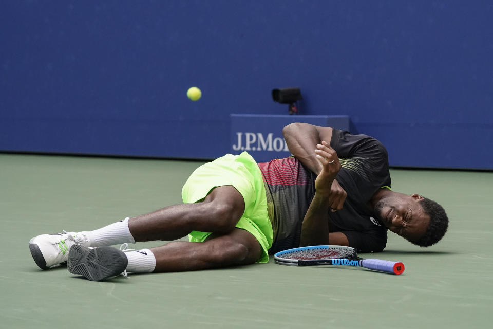 Gael Monfils, of France, reacts after falling to the court while chasing down a shot from Steve Johnson, of the United States, during the second round of the US Open tennis championships, Thursday, Sept. 2, 2021, in New York. (AP Photo/John Minchillo)