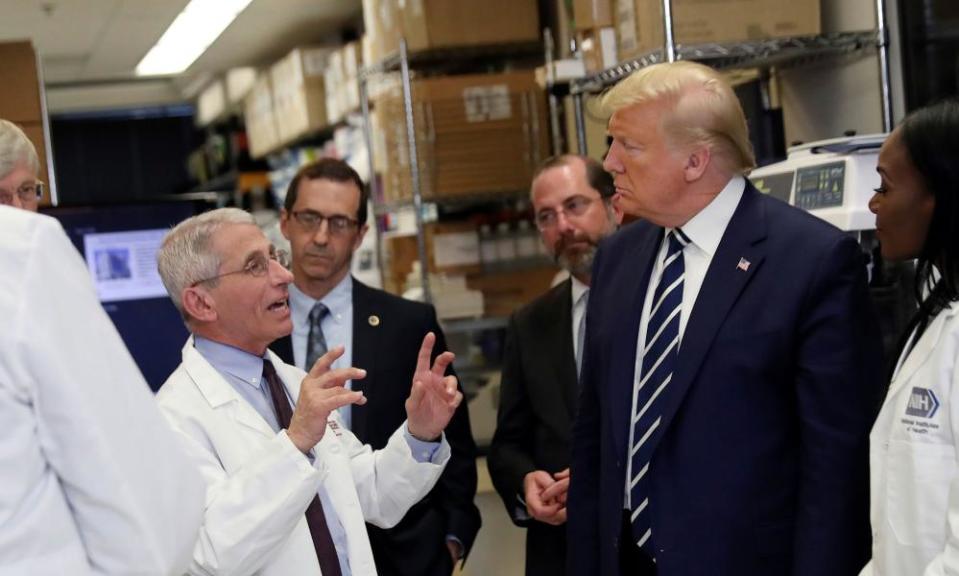 Dr Fauci speaks to US President Donald Trump during a tour of the National Institutes of Health.