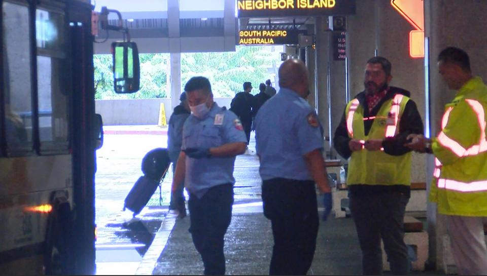 This image taken from video provided by Hawaii News Now shows the scene outside the international airport in Honolulu after nearly a dozen people were seriously injured when a flight to Hawaii hit severe turbulence on Sunday, Dec. 18, 2022. (Hawaii News Now via AP)