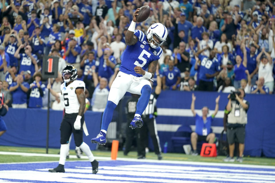 Indianapolis Colts quarterback Anthony Richardson, right, celebrates after scoring as Jacksonville Jaguars safety Andre Cisco is seen in the background during the first half of an NFL football game Sunday, Sept. 10, 2023, in Indianapolis. (AP Photo/Darron Cummings)