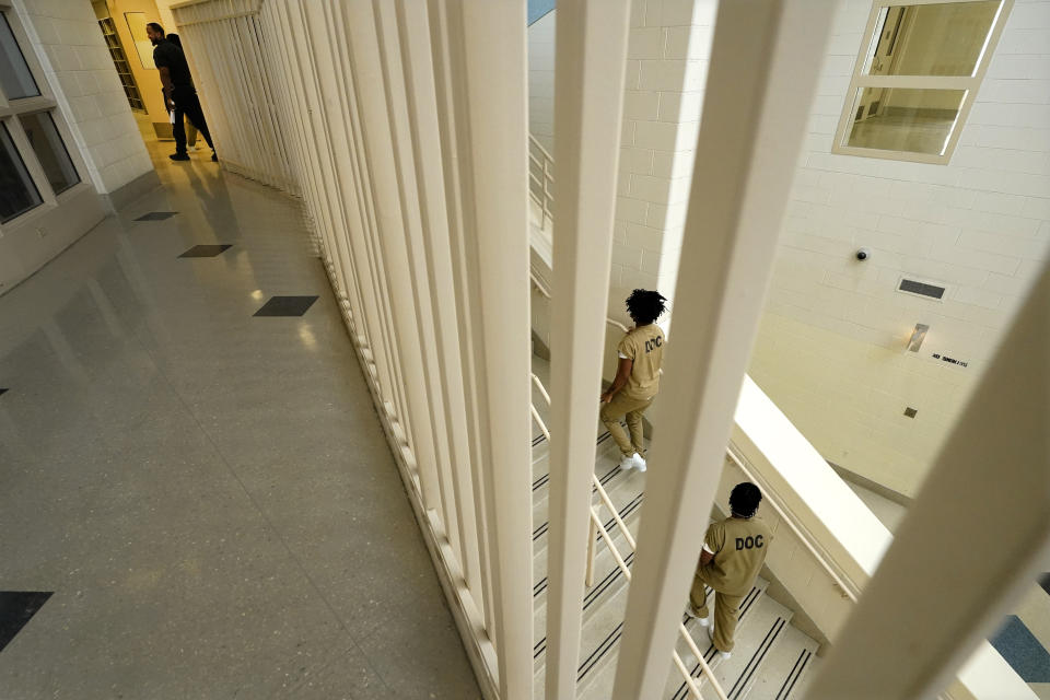 Inmates at the Cook County, Ill., jail head to a staging area at the jail's Division 11 law library before registering and voting in the local election on Saturday, Feb. 18, 2023, in Chicago. (AP Photo/Charles Rex Arbogast)