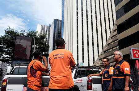 Members of the Civil Defense are seen in front of an evacuated building, after an earthquake that hit Bolivia, at Paulista avenue in Sao Paulo, Brazil April 2, 2018. The tremor was also felt in Brasilia and Sao Paulo. REUTERS/Leonardo Benassatto