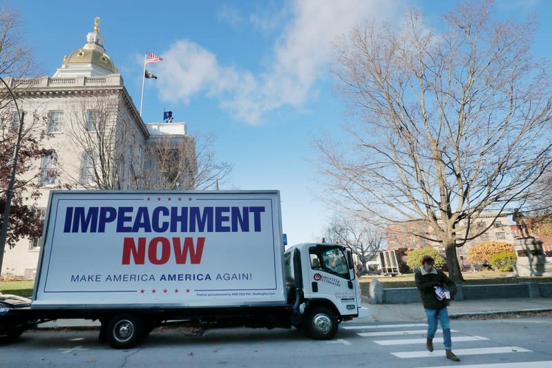 A truck with the sign "Impeachment Now" sits outside the statehouse in Concord