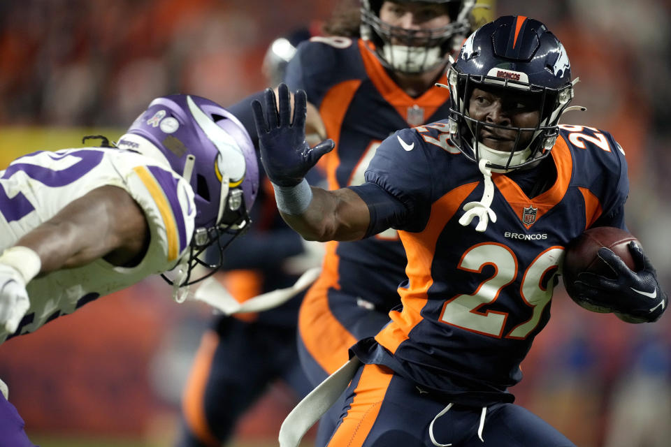 Denver Broncos cornerback Ja'Quan McMillian (29) is tackled after an interception against the Minnesota Vikings during the second half on an NFL football game, Sunday, Nov. 19, 2023, in Denver. (AP Photo/David Zalubowski)