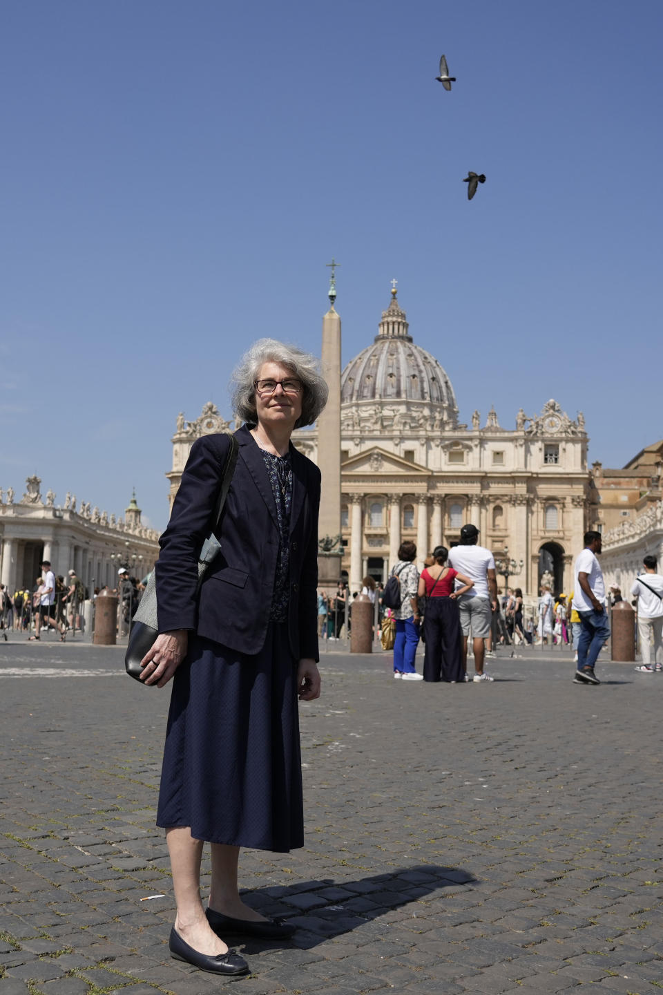 Sister Nathalie Becquart, the first female undersecretary in the Vatican's Synod of Bishops, poses for a photo in front of St. Peter's Square, Monday, May 29, 2023. In her years running Catholic youth programs in France, Becquart often invoked her own experience as a seasoned sailor in urging young people to weather the storms of their lives. “There’s nothing stronger than seeing the sunrise after a storm, the flat calm of the sea,” she says. (AP Photo/Alessandra Tarantino)