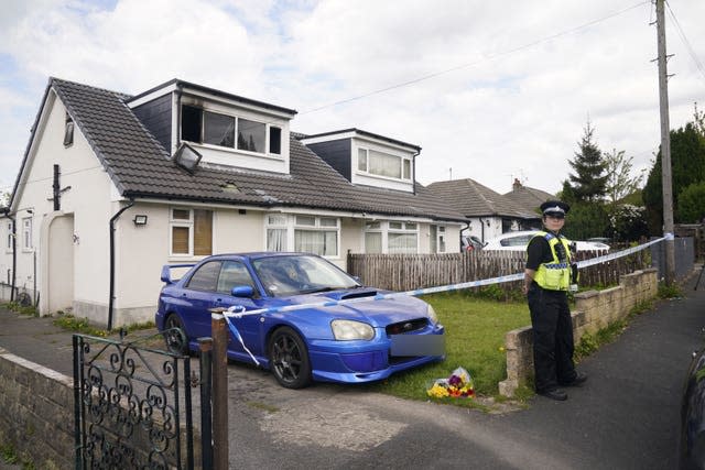 A police officer at the scene of a fatal house fire in Bradford. 