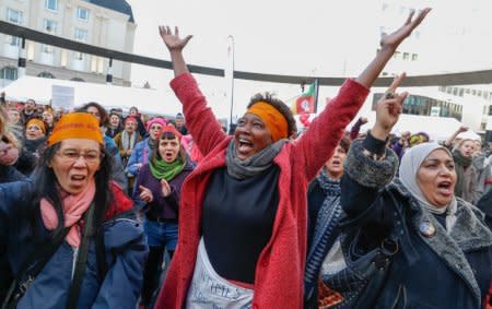 Women's right activists shout during a gathering on the street on International Women's Day in Brussels, Belgium March 8, 2018. REUTERS/Yves Herman