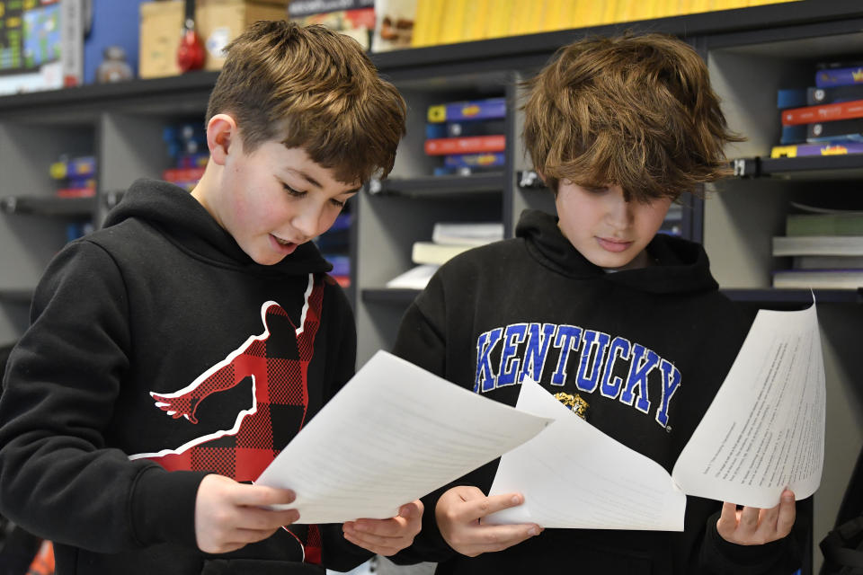 Miles Tunstill, left, and Grayson Pollard go over their lines of a three-scene play written by ChatGPT in Donnie Piercey's class at Stonewall Elementary in Lexington, Ky., Monday, Feb. 6, 2023. Parameters of the play were entered into the ChatGPT site, along with instructions to set the scenes inside a fifth-grade classroom. Line-by-line, it generated fully-formed scripts, which the students edited, briefly rehearsed and then performed. (AP Photo/Timothy D. Easley)