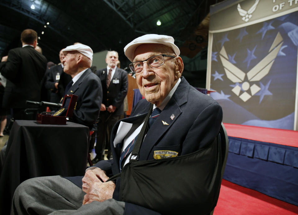 FILE - In this April 18, 2015, file photo, two members of the Doolittle Tokyo Raiders, retired U.S. Air Force Lt. Col. Richard "Dick" Cole, seated front, and retired Staff Sgt. David Thatcher, seated left, pose for photos after the presentation of a Congressional Gold Medal honoring the Doolittle Tokyo Raiders at the National Museum of the U.S. Air Force at Wright-Patterson Air Force Base in Dayton, Ohio. Retired Lt. Col. Richard "Dick" Cole, the last of the 80 Doolittle Tokyo Raiders who carried out the daring U.S. attack on Japan during World War II, has died at a military hospital in Texas. He was 103. A spokesman says Cole died Tuesday, April 9, 2019, at Brooke Army Medical Center in San Antonio, Texas. (AP Photo/Gary Landers, File)