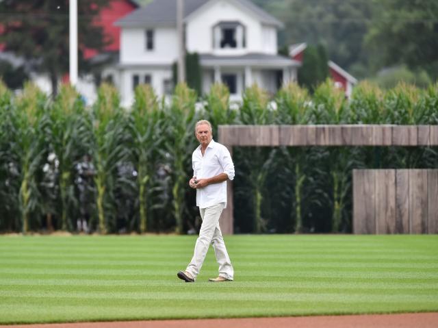 Kevin Costner leads the Yankees and White Sox out of the cornfield