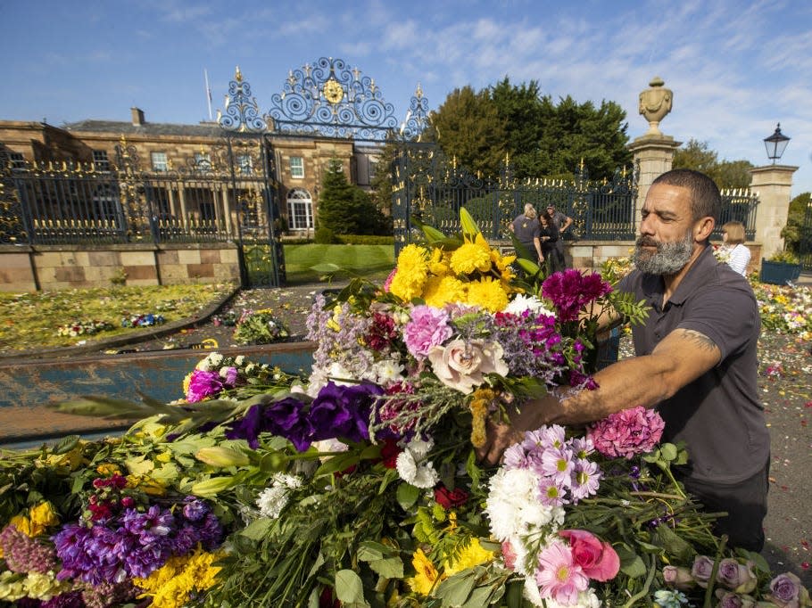 A man gathers flowers after Queen Elizabeth's funeral