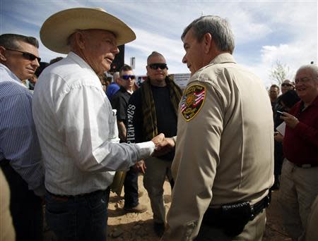 Rancher Cliven Bundy (2nd L) greets Clark County Sheriff Douglas Gillespie in Bunkerville, Nevada, April 12, 2014. Gillespie announced the Bureau of Land Management (BLM) was ceasing its cattle roundup operation. REUTERS/Jim Urquhart