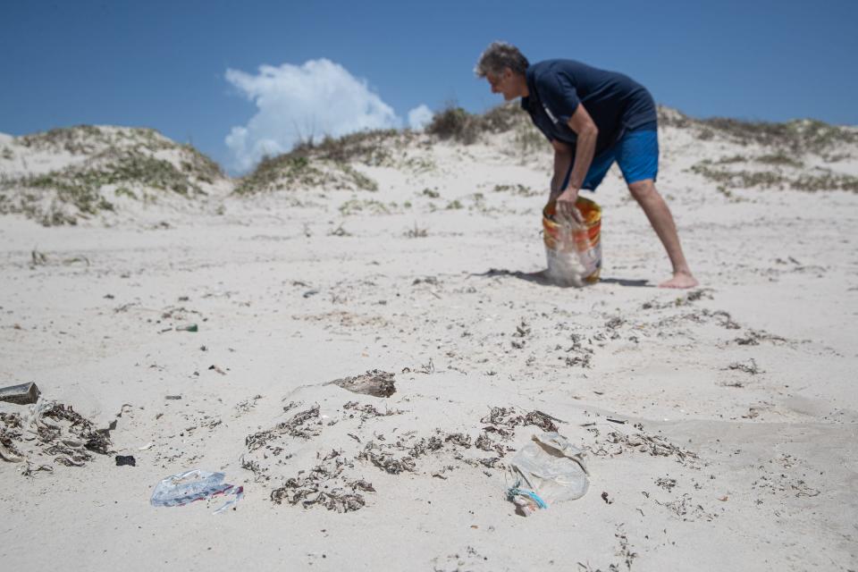 Beach Keepers founder Carl Lee Allen picks up litter at Mustang Island State Park on May 31, 2022, in Texas. The nonprofit is hosting a beach cleanup on Saturday, June 11, 2022. Allen said some trash is left behind but most of it washes up from the Gulf waters.