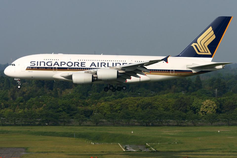 A Singapore Airlines plane landing at an airport