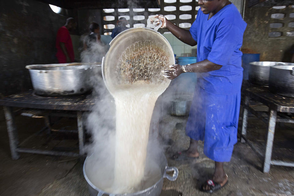 <p>A prisoner pours hot oatmeal into a a large stock pot in the kitchen of the National Penitentiary in downtown Port-au-Prince, Haiti, Feb. 13, 2017. Some inmates are provided meals by visiting relatives but the majority of prisoners are dependent on authorities to feed them twice a day and get little more than rationed supplies of rice, oats or cornmeal. (Photo: Dieu Nalio Chery/AP) </p>