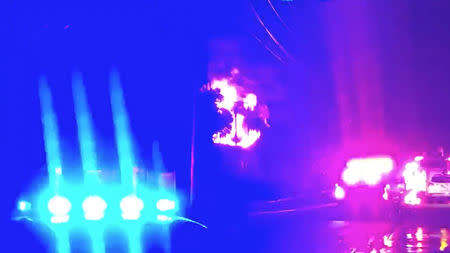 Lights flash from an emergency vehicle as a fire breaks out at an electrical substation in Fort Lauderdale, Florida, U.S., March 26, 2019 in this still image taken from a video from social media. JESSE SCOTT via REUTERS