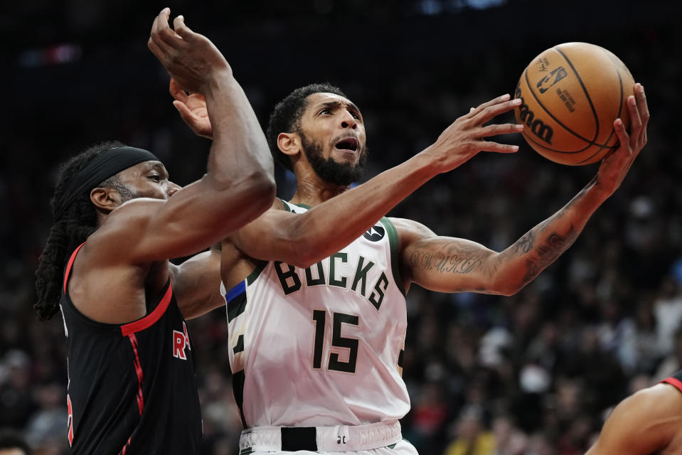 Milwaukee Bucks' Cameron Payne (15) drives past Toronto Raptors' Precious Achiuwa (5) during the first half of an NBA basketball game Wednesday, Nov. 15, 2023, in Toronto. (Frank Gunn/The Canadian Press via AP)