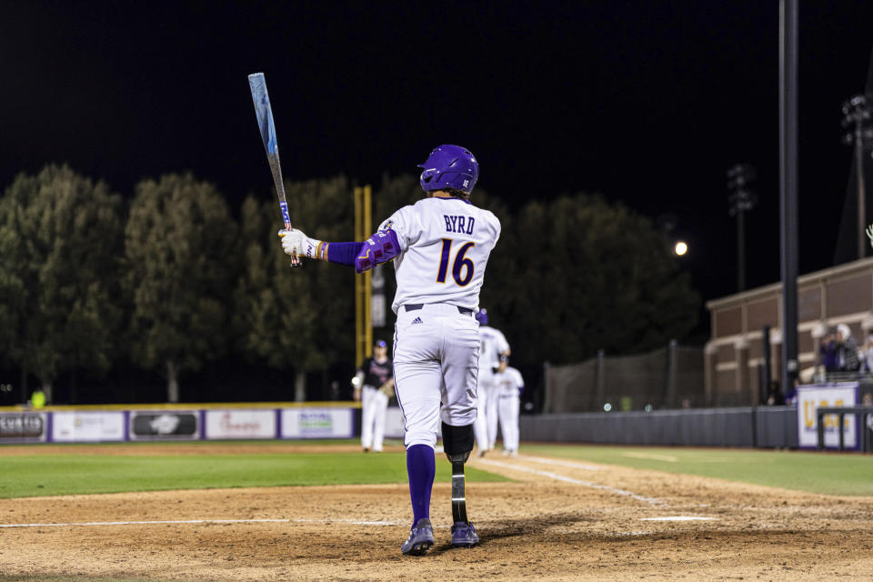 This photo provided by East Carolina University shows Parker Byrd during an NCAA college baseball game against Rider, Friday, Feb. 16, 2024 in Greenville, N.C. East Carolina sophomore Parker Byrd appeared in Friday’s season-opening win against Rider with a prosthetic leg after having part of his right leg amputated following a 2022 boating accident. The school said he is the first NCAA Division I athlete to play in a game with a prosthetic leg. (East Carolina University via AP)