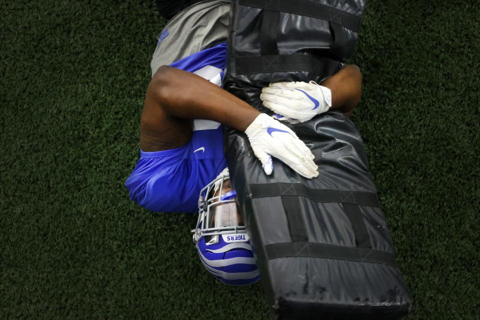 Memphis Tigers defensive lineman Camron Jackson tackles a dummy as they hold football practice at their indoor facility in the Billy J. Murphy football complex on Tuesday, March 23, 2021