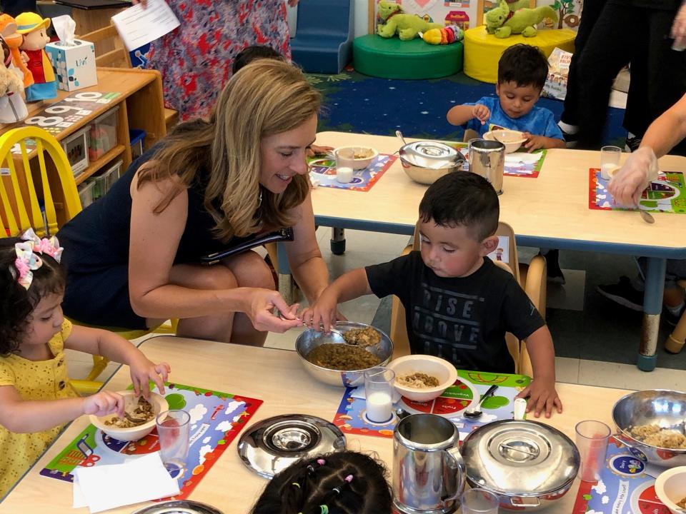 Rep. Mikie Sherrill, D-11th Dist., helps Logan, a student in the Early Head Start program, fill his lunch bowl at the Head Start Community Program of Morris County facility in Dover Tuesday, Sept. 5, 2023.