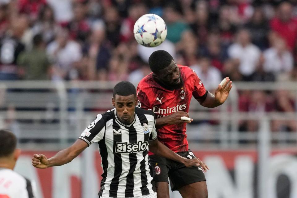 Newcastle's Alexander Isak, left, goes for the header with AC Milan's Fikayo Tomori.