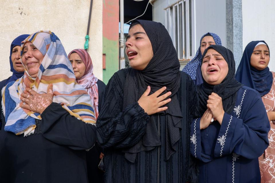 People mourn during the funeral of Palestinians killed in overnight Israeli shelling in Khan Yunis in the southern Gaza Strip on Tuesday.