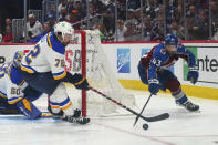 St. Louis Blues defenseman Justin Faulk (72) and Colorado Avalanche center Darren Helm (43) reach for the puck during the third period in Game 2 of an NHL hockey Stanley Cup second-round playoff series Thursday, May 19, 2022, in Denver. (AP Photo/Jack Dempsey)