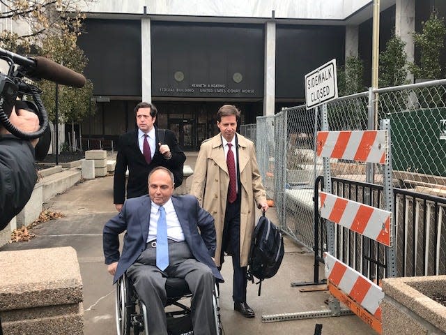 Developer Robert Morgan (forward in photo) leaves federal court in Rochester at earlier court appearance.