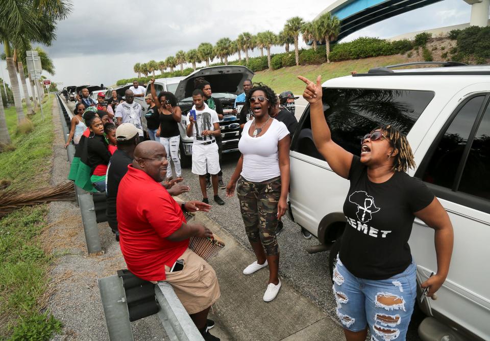 Protesters play drums and sing on the southbound exit ramp from Interstate 95 at PGA Boulevard -- where Corey Jones was fatally shot by a Palm Beach Gardens police officer October 18 -- following a protest on PGA Boulevard in front of The Gardens Mall Saturday, November 21, 2015.