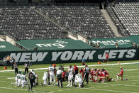 Players gather around an injured person during the first half of an NFL football game between the New York Jets and the San Francisco 49ers at a nearly empty MetLife Stadium, Sunday, Sept. 20, 2020, in East Rutherford, N.J. (AP Photo/Corey Sipkin)