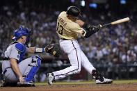 Arizona Diamondbacks' Nick Ahmed fouls a pitch off the face mask of Los Angeles Dodgers catcher Will Smith during the seventh inning of a baseball game Friday, June 18, 2021, in Phoenix. (AP Photo/Ross D. Franklin)