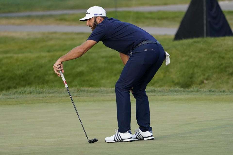 Dustin Johnson reacts to his missed putt on the playoff hole during the final round of the BMW Championship golf tournament at the Olympia Fields Country Club in Olympia Fields, Ill., Sunday, Aug. 30, 2020. Jon Rahm won the tournament. (AP Photo/Charles Rex Arbogast)